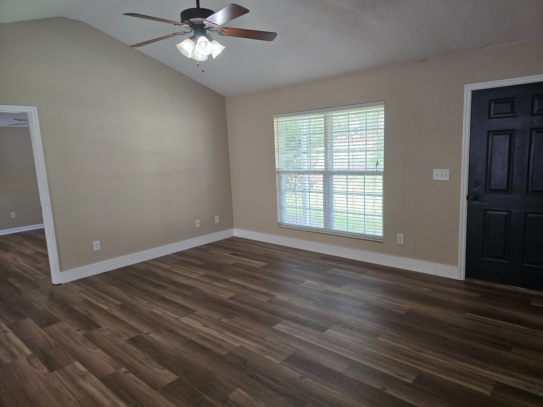Living room with wide window and black entry door