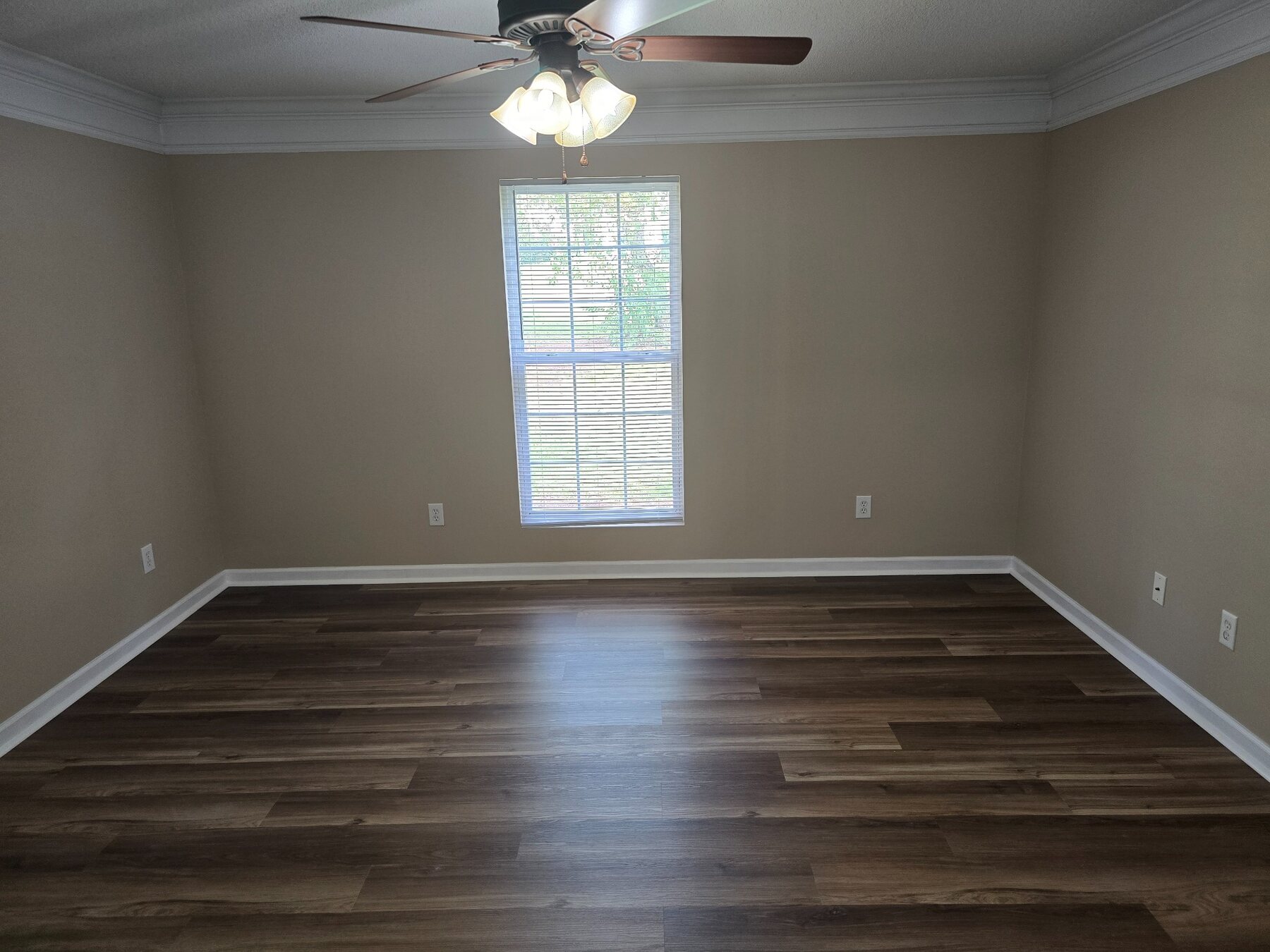 Bedroom with ceiling fan, tall window, and hard-surface flooring
