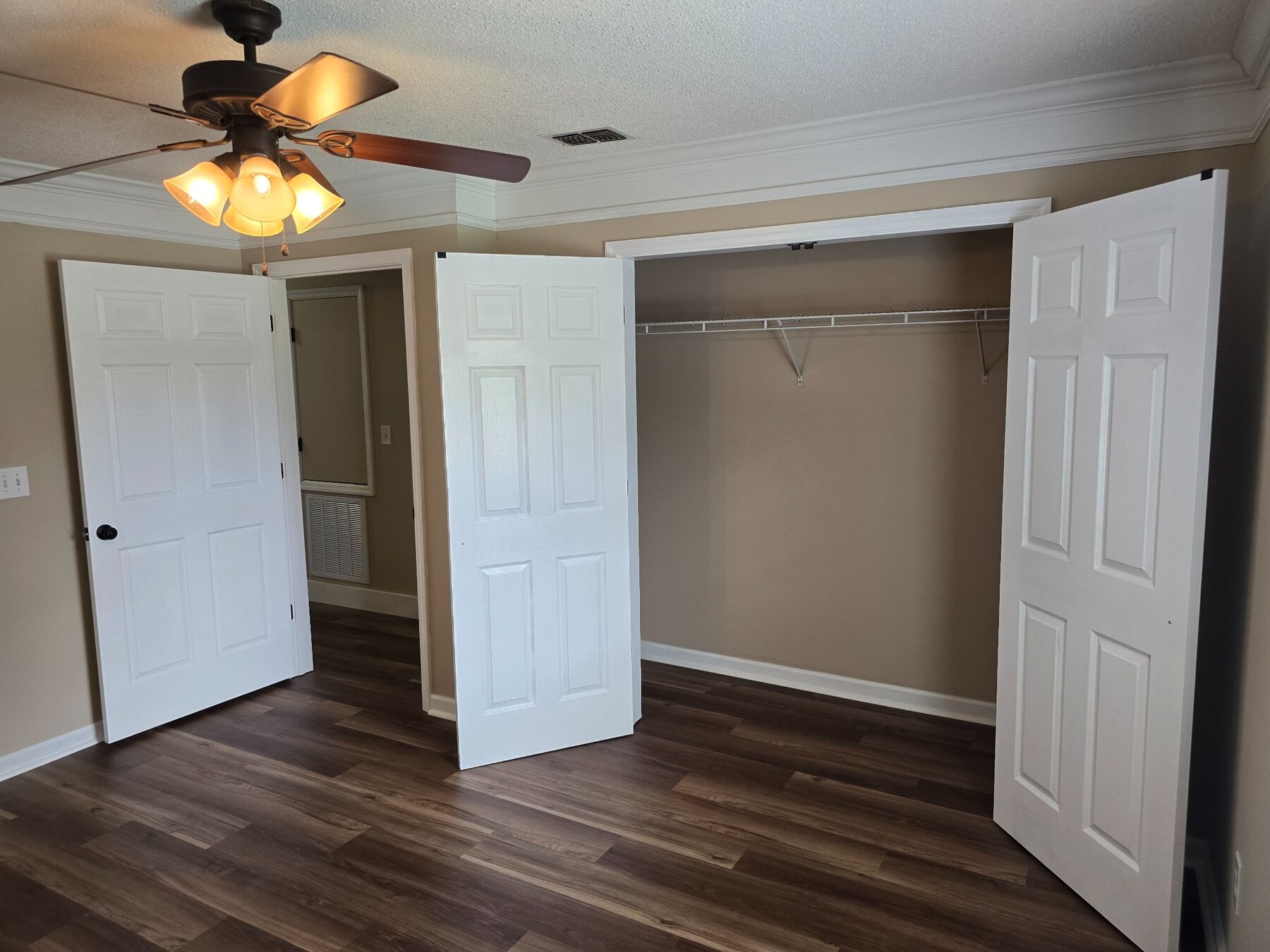 Bedroom showing two open closets and hard-surface flooring