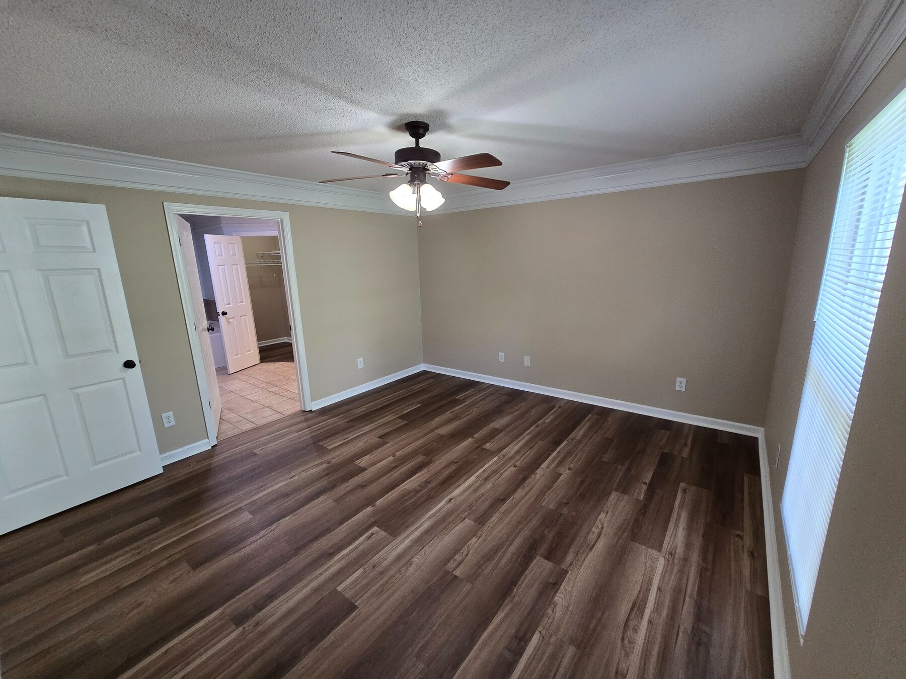 Bedroom with wide window, ceiling fan, and closet