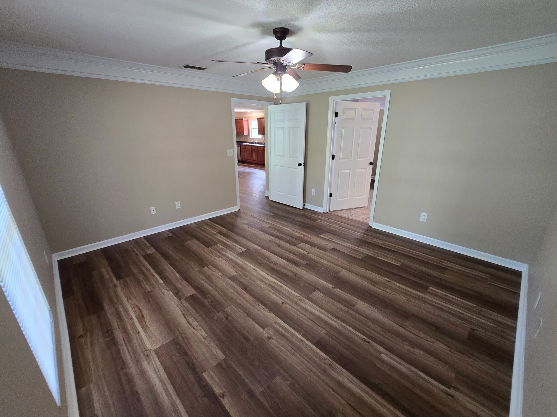 Bedroom with ceiling fan and doorway toward the kitchen