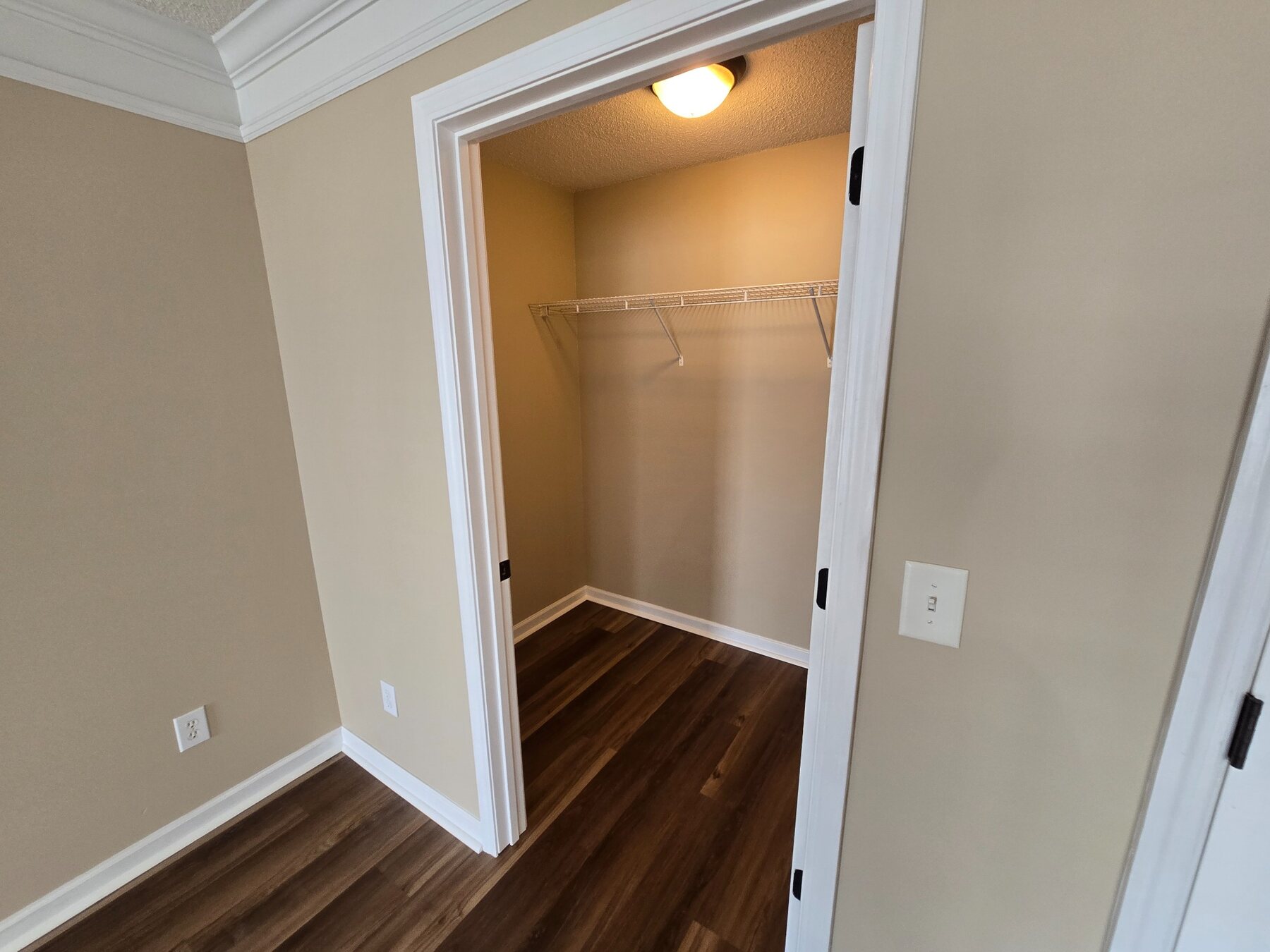 Walk-in closet with hard-surface flooring