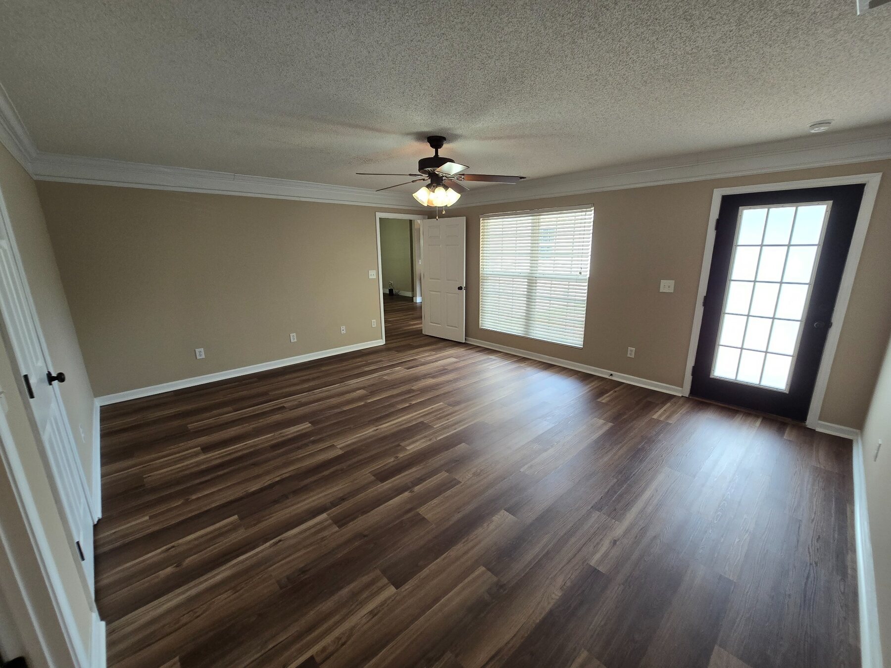 Open living area with wide window and exterior door