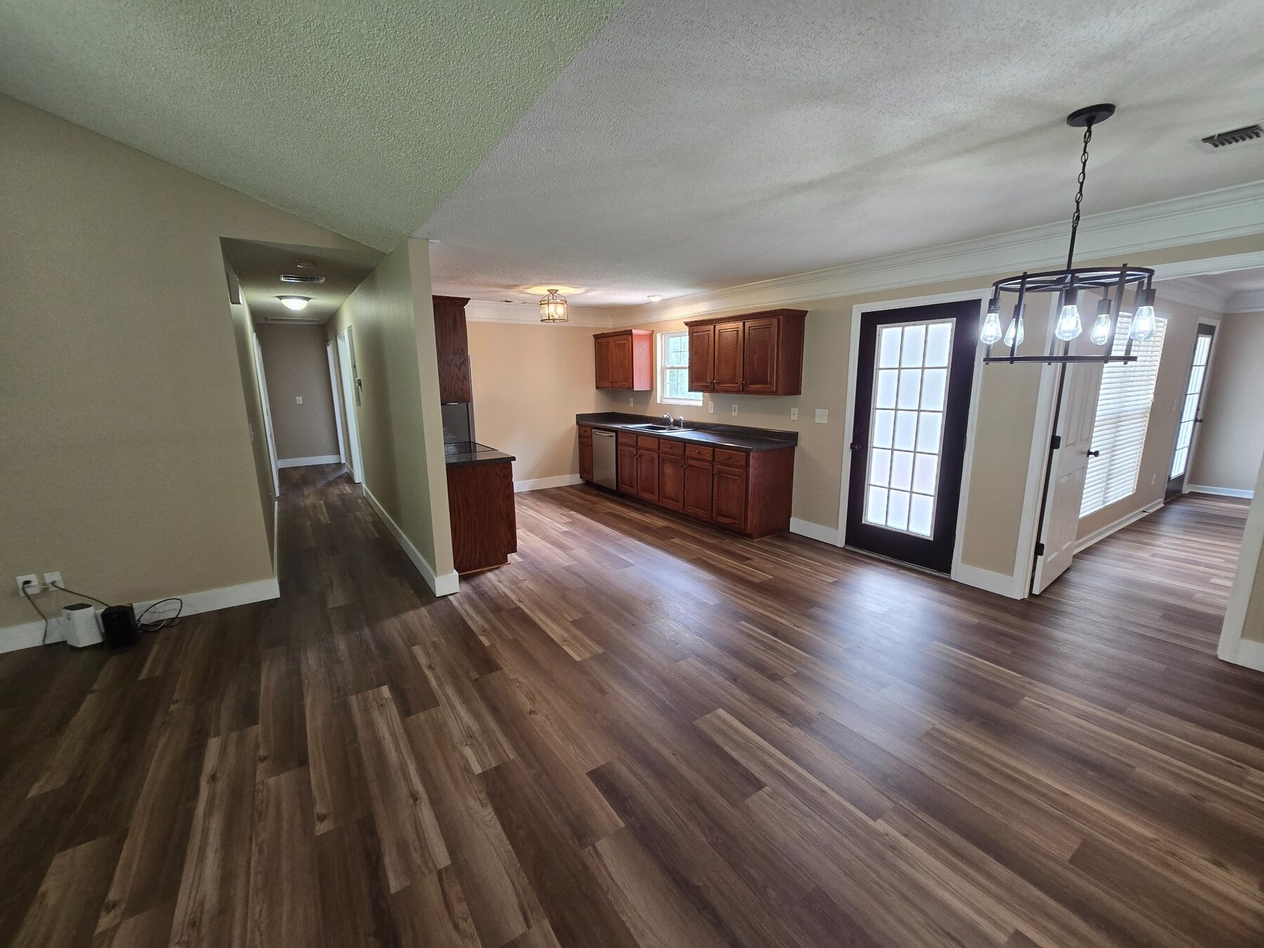 Open-plan living area looking toward kitchen and dining space
