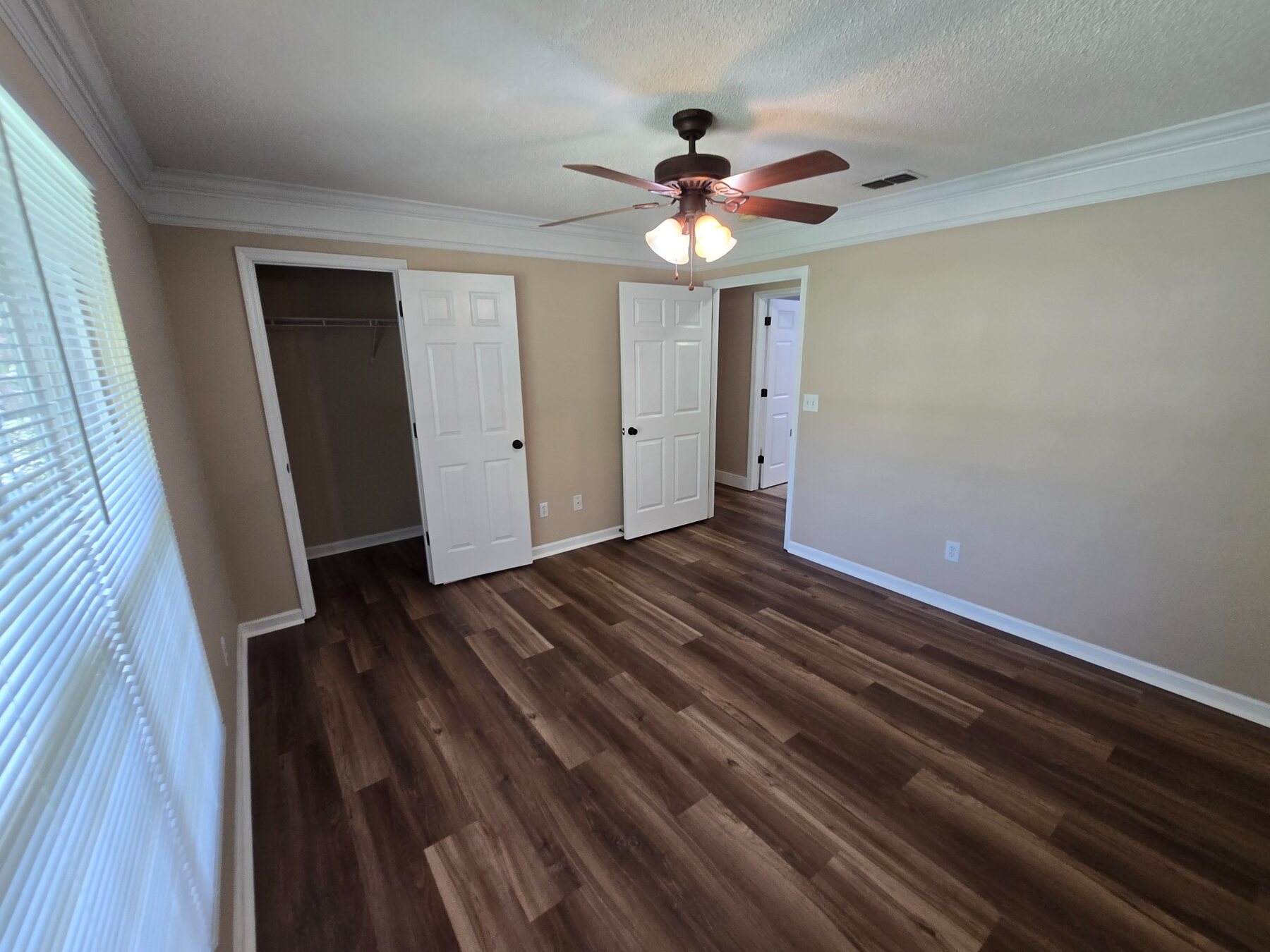 Alternate bedroom angle with window and closets