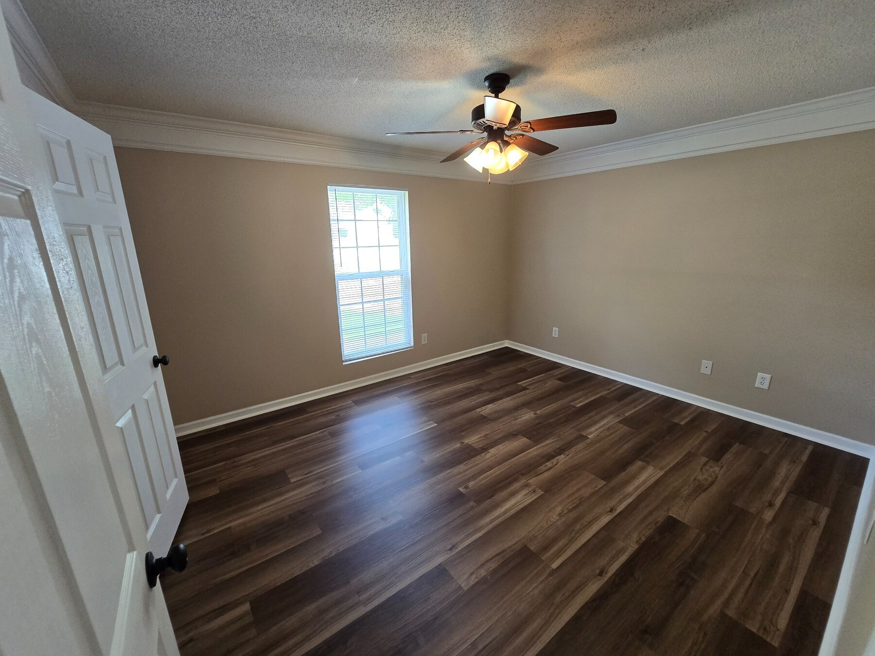 Bedroom with ceiling fan, window, and hard-surface flooring