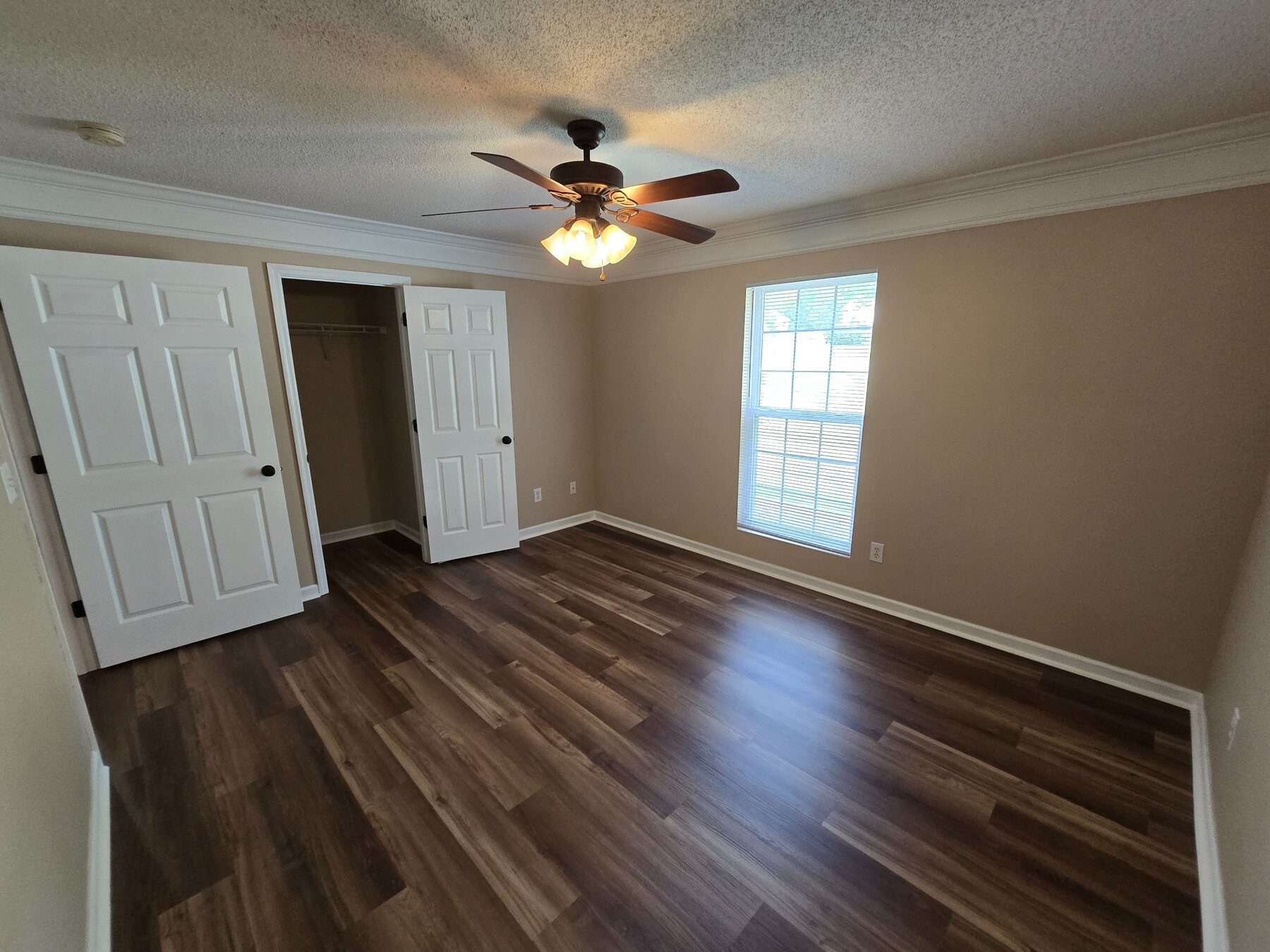 Alternate view of bedroom with window and open closet