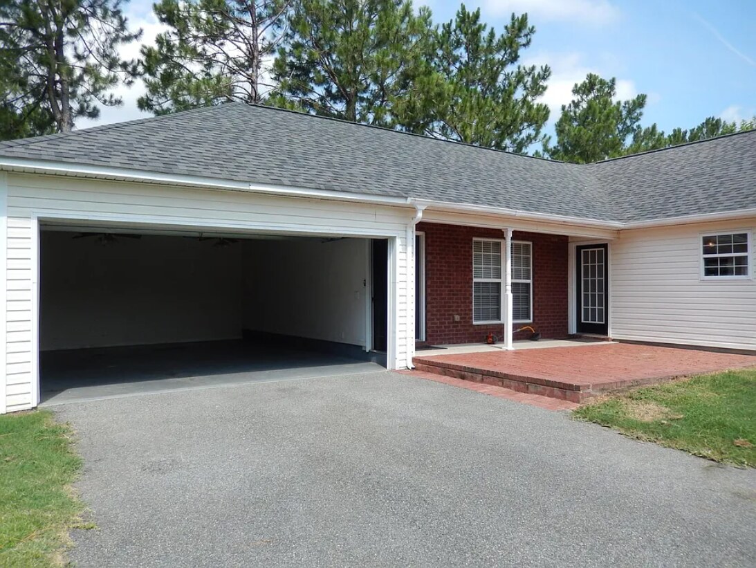 Attached two car garage, back covered area, and patio overlooking the large backyard